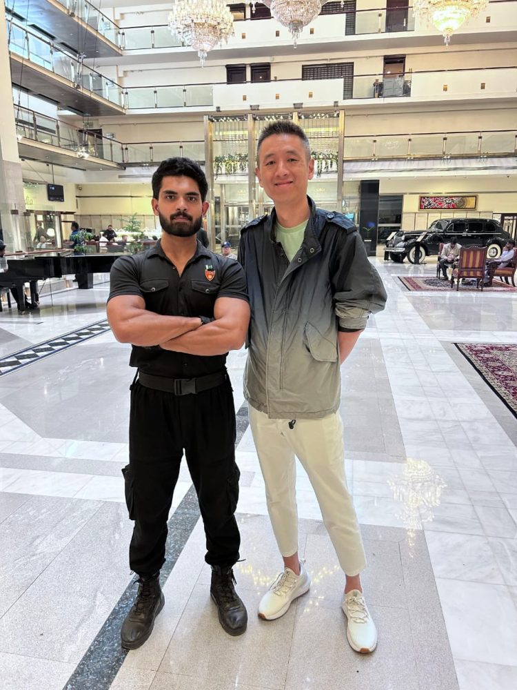 two men posing for a picture al raad security services lahore